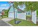 Detached garage with a basketball hoop and access to the fenced backyard of the turquoise home at 300 Foxglove Ave, Summerville, SC 29483