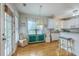 Bright eat-in kitchen featuring white cabinets, granite counters, bar seating, and stylish decor at 300 Foxglove Ave, Summerville, SC 29483