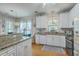 Well-appointed kitchen with granite counters, white cabinets, and modern appliances at 300 Foxglove Ave, Summerville, SC 29483