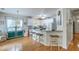 Open kitchen with white cabinets, granite countertops, bar seating, and hardwood floors at 300 Foxglove Ave, Summerville, SC 29483