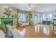Spacious living room connecting to the kitchen featuring hardwood floors and a fireplace at 300 Foxglove Ave, Summerville, SC 29483