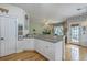 Open layout between kitchen and living room with granite counters, white cabinets, and fireplace at 300 Foxglove Ave, Summerville, SC 29483