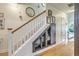 Carpeted staircase with white railings, hardwood floors and stylish storage at 300 Foxglove Ave, Summerville, SC 29483