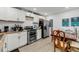 Well-lit kitchen with stainless steel appliances, white cabinets, and light wood flooring at 3043 Matipan Ave, North Charleston, SC 29405