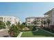 Condo buildings surrounded by lush greenery and flowering trees at 325 Longshore St # 1122, Daniel Island, SC 29492