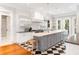 Spacious kitchen features a central island, black and white tiled floors, and modern stainless appliances at 34 Eugenia Ave # B, Kiawah Island, SC 29455
