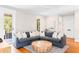 Inviting living room features a comfortable sectional sofa, round coffee table, and access to outdoor space at 34 Eugenia Ave # B, Kiawah Island, SC 29455