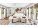 Cozy primary bedroom featuring bright natural light, calming decor, and direct access to a private balcony at 34 Eugenia Ave # B, Kiawah Island, SC 29455