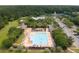 Aerial view of community pool with chairs, tables, and umbrellas surrounded by mature trees at 3588 Bagley Dr, Mount Pleasant, SC 29466