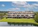 Rear view of townhomes overlooking a scenic pond, with private patios and manicured green lawns at 3588 Bagley Dr, Mount Pleasant, SC 29466