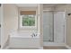 Bright bathroom with soaking tub, shower, and window providing natural light and outdoor view at 3588 Bagley Dr, Mount Pleasant, SC 29466