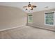 Spacious bedroom with neutral carpet, a ceiling fan and abundant natural light from two windows at 3588 Bagley Dr, Mount Pleasant, SC 29466