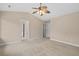 Spacious bedroom with neutral carpet, a ceiling fan, windows, closet, and bathroom access at 3588 Bagley Dr, Mount Pleasant, SC 29466