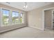Bedroom features three windows for natural light, ceiling fan, and door to hallway at 3588 Bagley Dr, Mount Pleasant, SC 29466
