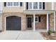 A welcoming entrance with a black front door, brick facade, and a well-maintained garage door at 3588 Bagley Dr, Mount Pleasant, SC 29466