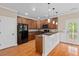 A kitchen with hardwood flooring, wood cabinets, a breakfast bar, and stainless steel appliances at 3588 Bagley Dr, Mount Pleasant, SC 29466