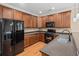 Kitchen featuring wood cabinets, stone countertops, stainless appliances, and hardwood flooring at 3588 Bagley Dr, Mount Pleasant, SC 29466