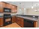 Kitchen featuring wood cabinets, stone countertops, stainless appliances, and hardwood flooring at 3588 Bagley Dr, Mount Pleasant, SC 29466