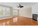 Bright living room with hardwood floors, a fireplace, large windows, and a modern ceiling fan at 3588 Bagley Dr, Mount Pleasant, SC 29466