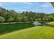 Scenic view of the lush pond with a fountain surrounded by trees and greenery at 3588 Bagley Dr, Mount Pleasant, SC 29466