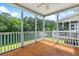Inviting screened porch with wood flooring, overlooking a picturesque pond surrounded by lush greenery at 3588 Bagley Dr, Mount Pleasant, SC 29466