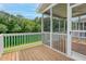 Relaxing screened porch featuring wooden floors and offering serene views of the surrounding greenery at 3588 Bagley Dr, Mount Pleasant, SC 29466