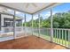 Inviting screened porch with wood flooring, overlooking a picturesque pond surrounded by lush greenery at 3588 Bagley Dr, Mount Pleasant, SC 29466