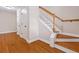 Elegant staircase featuring hardwood steps, white risers, and a stained wood railing; hardwood floor on landing at 3588 Bagley Dr, Mount Pleasant, SC 29466