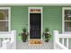 Charming entryway with a classic black door and decorative plants at 3636 Purple Martin Ct, Mount Pleasant, SC 29466