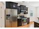 Well-equipped kitchen featuring stainless steel appliances and dark cabinetry with modern hardware at 3636 Purple Martin Ct, Mount Pleasant, SC 29466