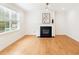 Bright living room featuring a black fireplace and large windows overlooking a green landscape at 3636 Purple Martin Ct, Mount Pleasant, SC 29466