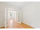 Spacious living room with wood floors leading to the dining room through open, glass-paned doors at 3636 Purple Martin Ct, Mount Pleasant, SC 29466