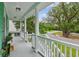 Inviting front porch featuring elegant white columns and a scenic neighborhood view at 3636 Purple Martin Ct, Mount Pleasant, SC 29466