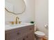 Stylish powder room showcasing a gold-trimmed mirror and accents, complemented by a modern sink and toilet at 3636 Purple Martin Ct, Mount Pleasant, SC 29466