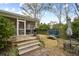 Backyard featuring a covered patio, table, grill, and trampoline at 38 Colleton Dr, Charleston, SC 29407