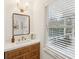 Bright powder room featuring a vanity with a quartz countertop, modern fixtures, and a window at 38 Colleton Dr, Charleston, SC 29407