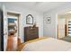 Comfortable bedroom with hardwood floors, dresser, closet, and connecting rooms visible through doorways at 38 Colleton Dr, Charleston, SC 29407