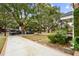 Inviting front yard with long driveway, lush greenery, and mature trees at 38 Colleton Dr, Charleston, SC 29407