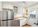 Bright kitchen with stainless steel appliances, white cabinetry, and a convenient door to the backyard at 38 Colleton Dr, Charleston, SC 29407