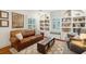 Stylish living room featuring a leather sofa, built-in shelving, and a rustic wooden coffee table with storage at 38 Colleton Dr, Charleston, SC 29407