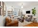Bright living room with built-in shelving, hardwood floors, and comfortable seating area with stylish furnishings at 38 Colleton Dr, Charleston, SC 29407