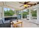 Screened porch featuring an outdoor sofa, lighting, and a ceiling fan at 38 Colleton Dr, Charleston, SC 29407