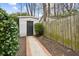 Backyard featuring a white storage shed with black door and a brick path leading to it at 38 Colleton Dr, Charleston, SC 29407