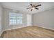 Spacious bedroom with ceiling fan, wood-look floors, and large window offering natural light at 4054 Cedars Pkwy # C, North Charleston, SC 29420