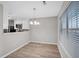 Open dining area with a modern chandelier and lots of sunlight; kitchen in the background at 4054 Cedars Pkwy # C, North Charleston, SC 29420