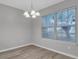 Cozy dining area with modern chandelier, neutral walls and large window at 4054 Cedars Pkwy # C, North Charleston, SC 29420