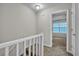 Well-lit hallway with carpet flooring leads to a bedroom with a ceiling fan at 4054 Cedars Pkwy # C, North Charleston, SC 29420