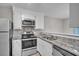 Updated kitchen boasts white cabinets, granite countertops, and stainless steel appliances at 4054 Cedars Pkwy # C, North Charleston, SC 29420