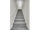 Carpeted staircase with white railing leading to the upper level of the home at 4054 Cedars Pkwy # C, North Charleston, SC 29420