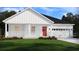 Charming one-story home featuring a welcoming front porch, white siding, a red door, and an attached two-car garage at 420 Radiant Blue Way, Summerville, SC 29486